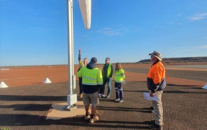 A small group inspect a windsock at a rural airfield during a Southpac Aerodrome Reporting Officer (ARO) Course.